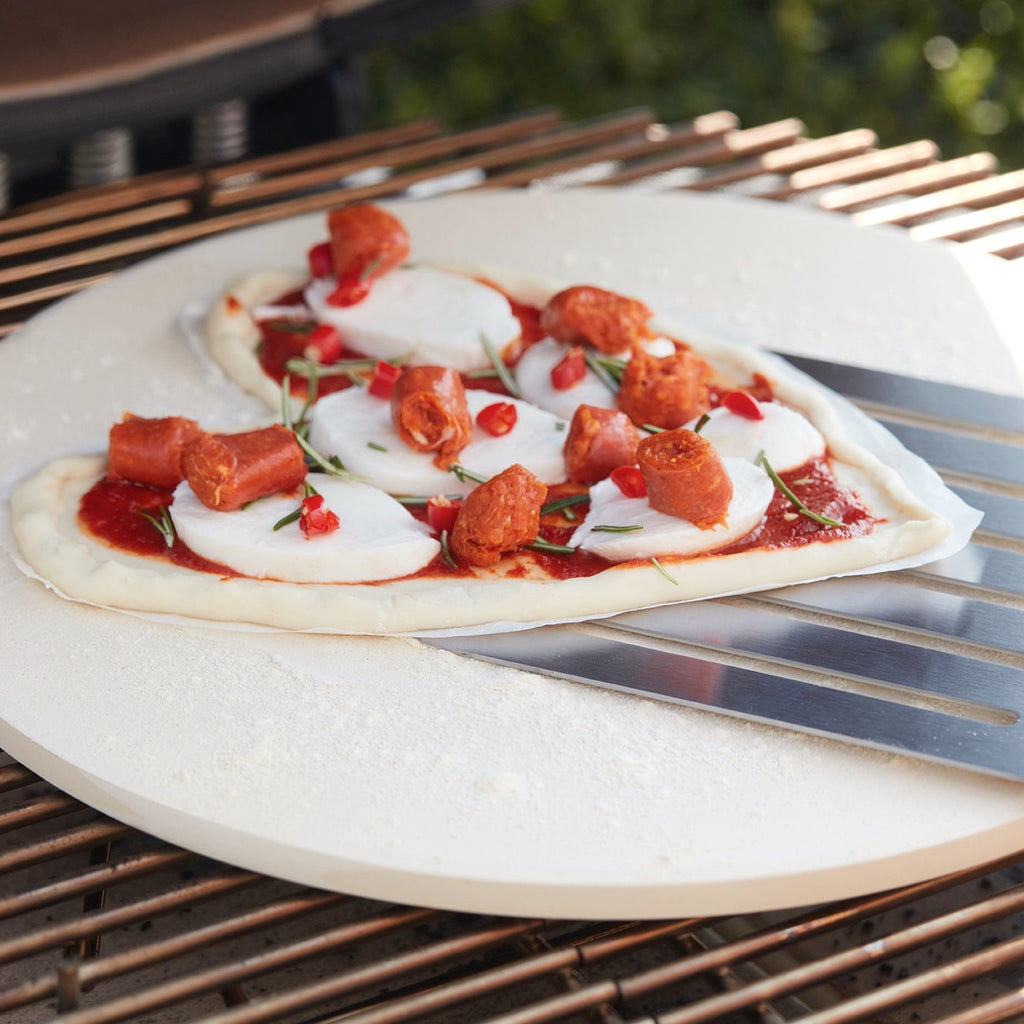 Pizza with merguez, mozzarella and tomato on the BBQ