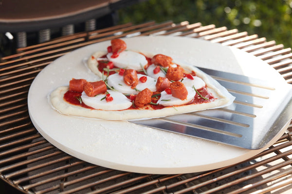 Pizza with merguez, mozzarella and tomato on the BBQ